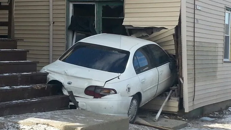 Car runs into house